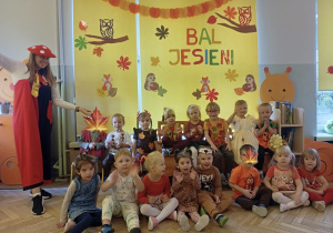 Zdjęcie grupowe dzieci z grupy 2 na tle jesiennej dekoracji