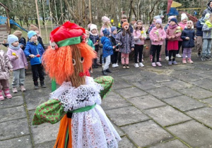 Dzieci śpiewają piosenkę stojąc na przeciwko Marzanny